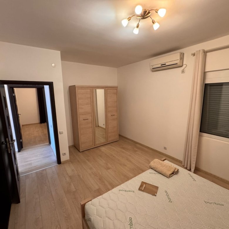 Modern Ulcinj bedroom for sale: wooden floors, mirrored wardrobe, AC. Invest with immorenta.me by Ekosphere doo.