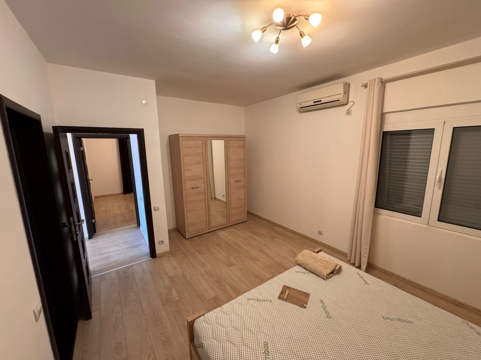 Modern Ulcinj bedroom for sale: wooden floors, mirrored wardrobe, AC. Invest with immorenta.me by Ekosphere doo.