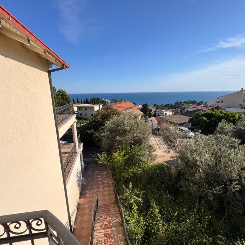 Stunning balcony view over Ulcinj real estate: beige building, lush greenery, sea views&mdash;prime investment via immorenta.me by ekosphere doo.