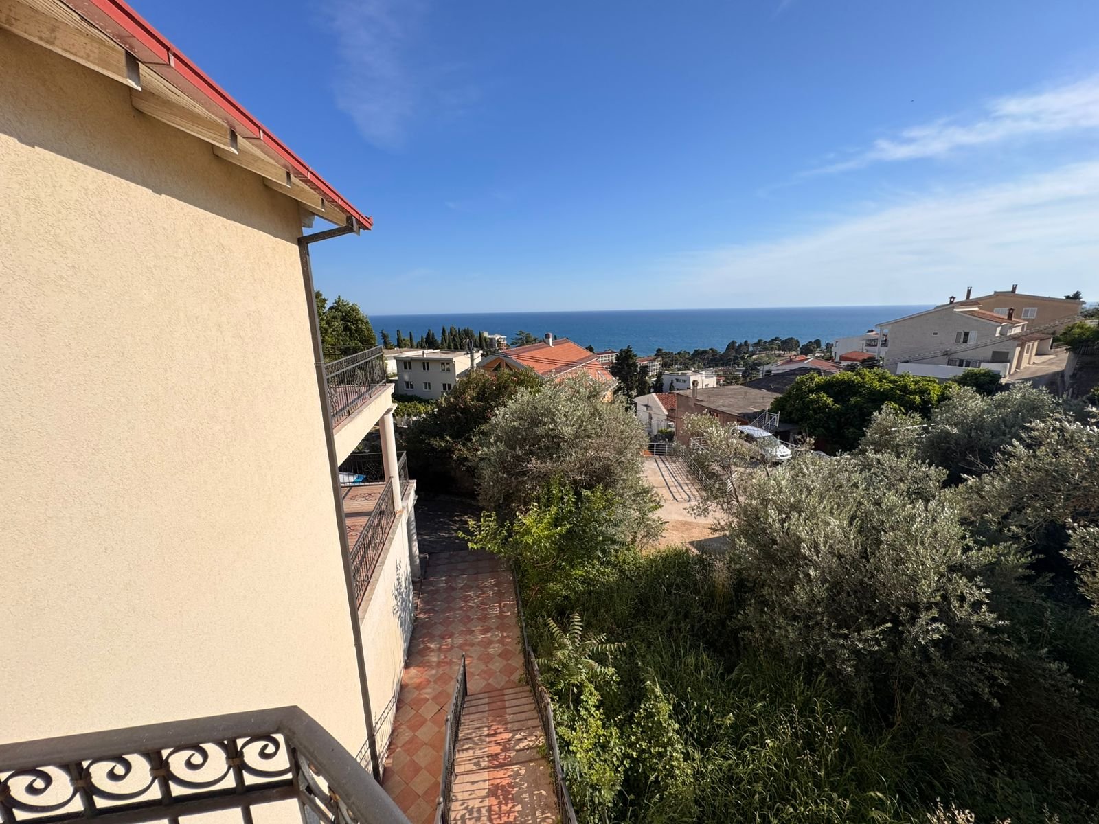 Stunning balcony view over Ulcinj real estate: beige building, lush greenery, sea views&mdash;prime investment via immorenta.me by ekosphere doo.