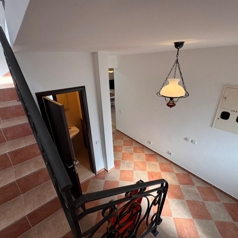 Elegant staircase view of an Ulcinj property with stylish tiles, metal rails, and open doors&mdash;exclusive on immorenta.me by Ekosphere doo.