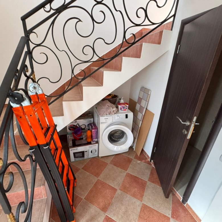 Modern under-stair laundry in Ulcinj Montenegro property: washing machine, storage, tile floor&mdash;exclusive on immorenta.me by ekosphere doo.