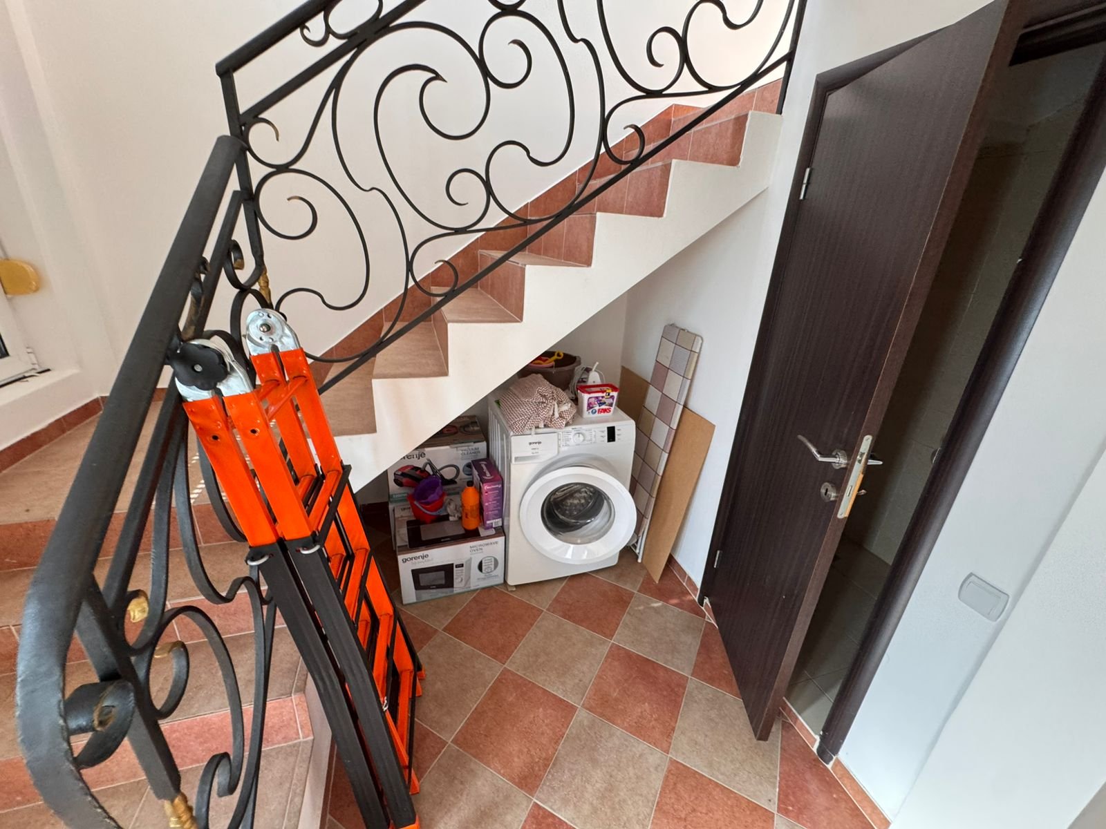 Modern under-stair laundry in Ulcinj Montenegro property: washing machine, storage, tile floor&mdash;exclusive on immorenta.me by ekosphere doo.