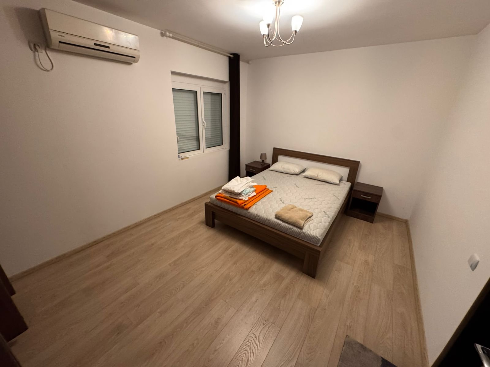 Modern minimalist bedroom in Ulcinj, Montenegro with double bed, AC, stylish flooring&mdash;ideal property investment at immorenta.me.