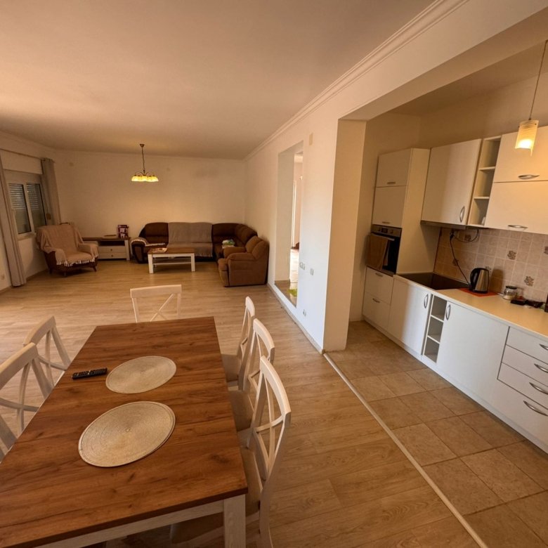 Luxurious open-plan living in Ulcinj, Montenegro&mdash;modern kitchen, central dining, light wood floors. Invest with immorenta.me by ekosphere doo.