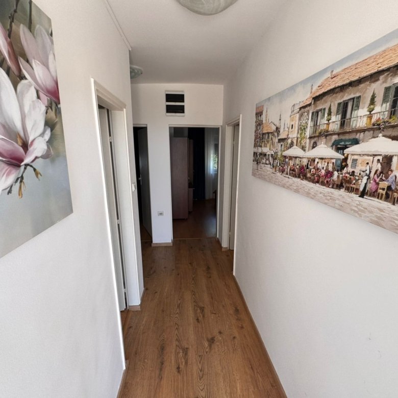 Elegant hallway in Ekosphere, Ulcinj: wood floors, bright walls, art accents, sunlit&mdash;prime Montenegro property on immorenta.me.