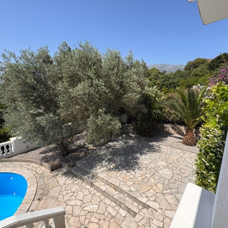 Premium Ulcinj property: stone patio, lush garden, pool & blue skies. Invest in Montenegro real estate with immorenta.me by ekosphere doo.