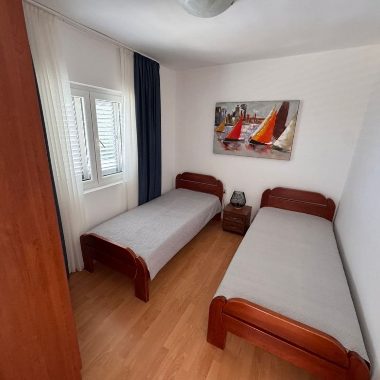 Charming Ulcinj bedroom: two single beds, modern decor, ideal investment. Listed on immorenta.me by ekosphere doo.