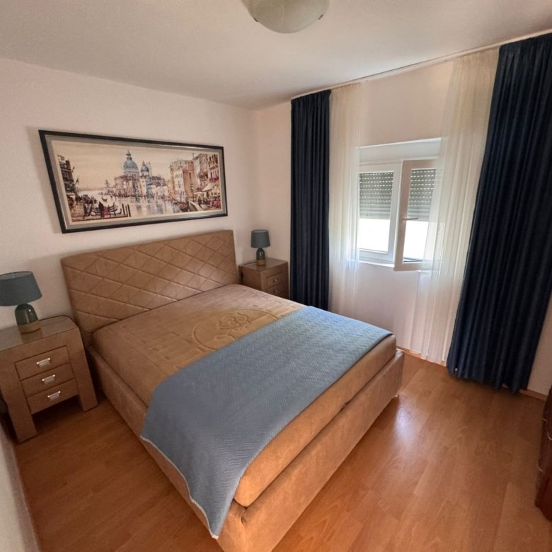 Modern Ulcinj apartment with blue-accented bedroom, wood floors, and quality finishes&mdash;invest via immorenta.me by ekosphere doo.