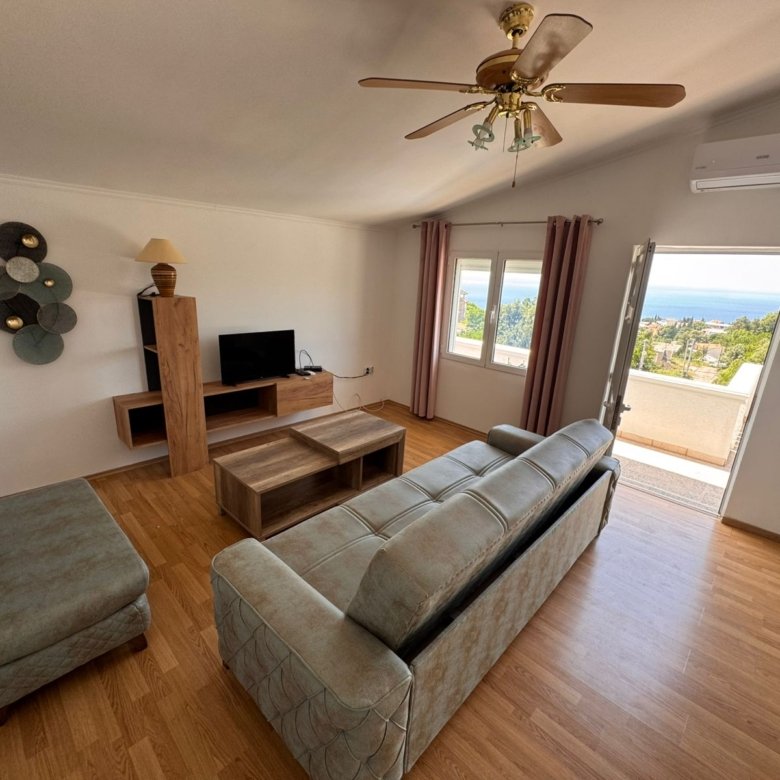 Modern Ulcinj apartment: wood floors, cozy sofa, balcony with sea & green views. Prime investment via immorenta.me by ekosphere doo.