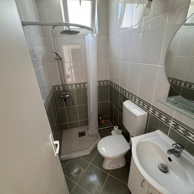 Modern small bathroom in Ulcinj property: tiled, corner shower, stylish fixtures. Invest via immorenta.me by Ekosphere doo.