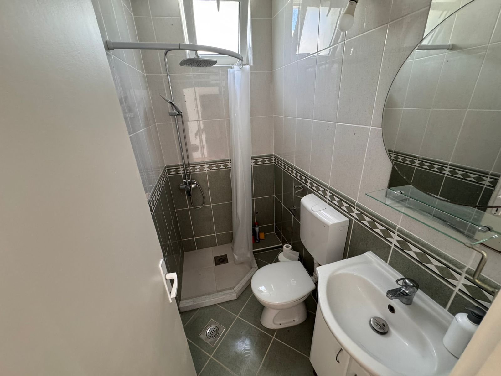 Modern small bathroom in Ulcinj property: tiled, corner shower, stylish fixtures. Invest via immorenta.me by Ekosphere doo.