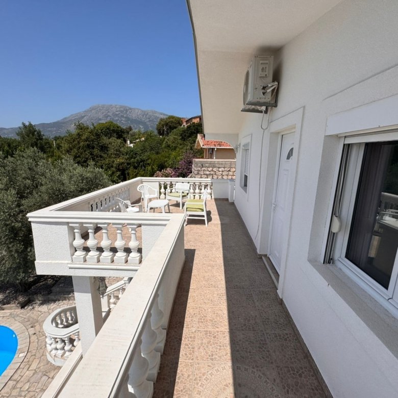 Elegant white balcony with tiled floor, pool view, scenic mountains&mdash;prime Ulcinj real estate by Ekosphere DOO at immorenta.me.