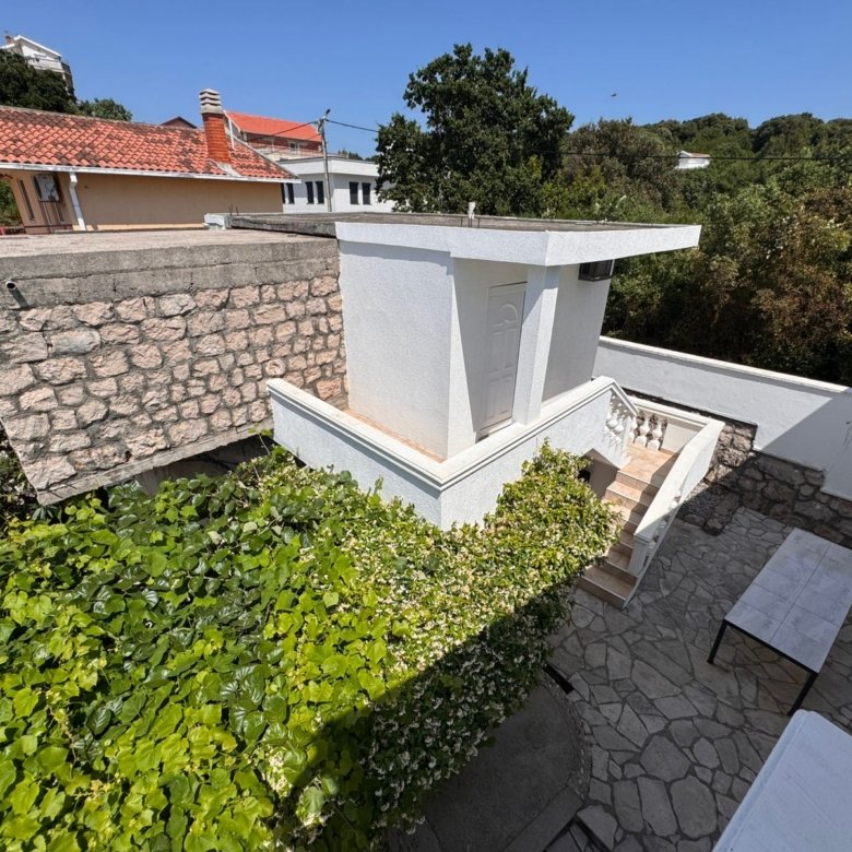 Charming white home in Ulcinj, Montenegro, with stone walls and lush greenery&mdash;ideal real estate investment at immorenta.me by ekosphere doo.