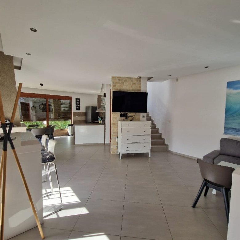 Stunning Ulcinj open-plan living: tiled floors, gray sectional, large windows. Prime investment by Ekosphere&mdash;immorenta.me.