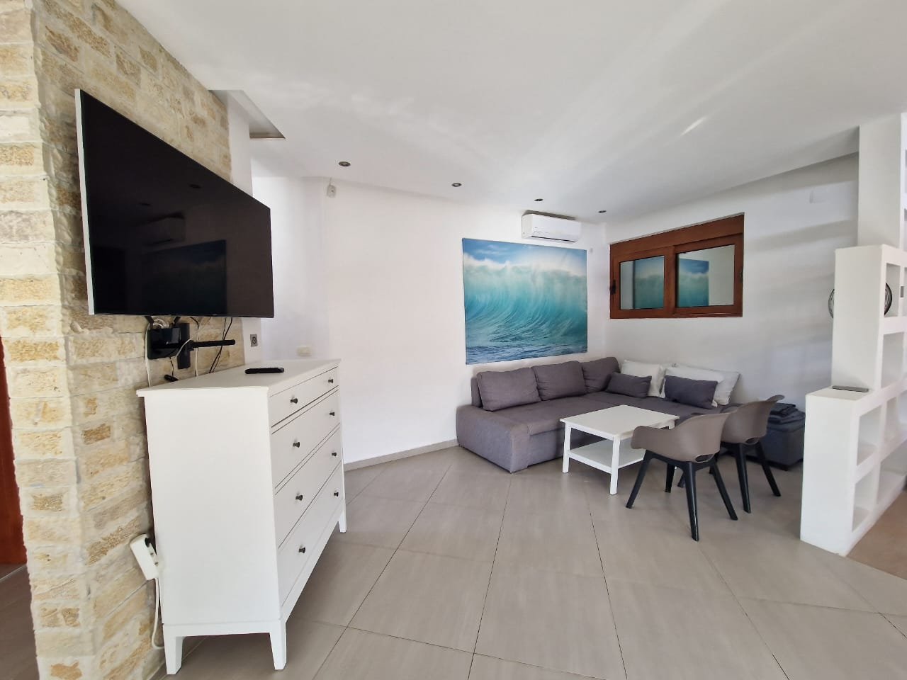 Elegant Ulcinj living room with gray sectional, white accents, and modern art. Ideal investment&mdash;exclusive on immorenta.me by ekosphere doo.