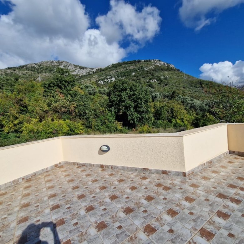 Spacious tiled terrace with beige walls in Ulcinj, Montenegro, boasting stunning green views&mdash;listed on immorenta.me by Ekosphere doo.