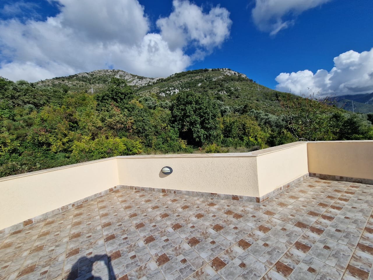 Spacious tiled terrace with beige walls in Ulcinj, Montenegro, boasting stunning green views&mdash;listed on immorenta.me by Ekosphere doo.