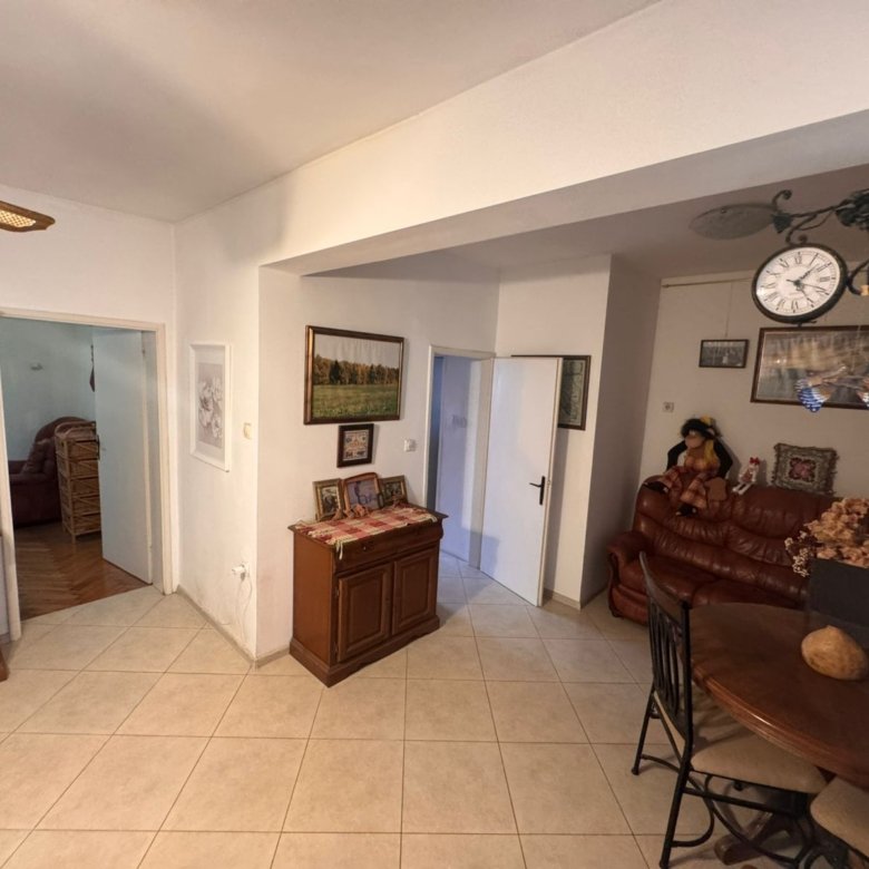 Stylish Ulcinj living room with tiled floors, wooden accents, dining area, and sofa&mdash;premium property by Ekosphere on immorenta.me.