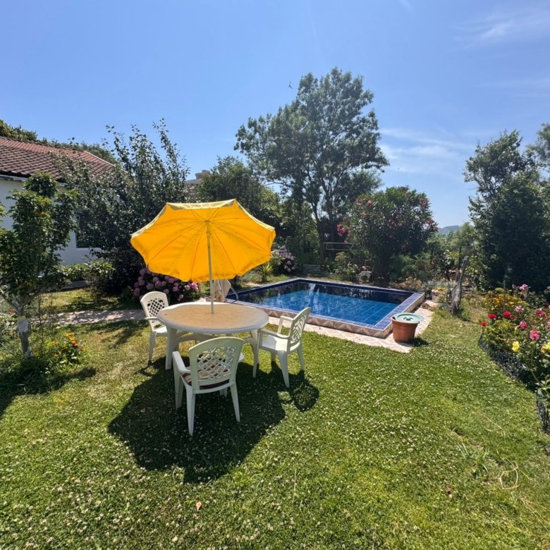 Chic outdoor oasis with pool, lush lawn, and stylish seating&mdash;ideal Ulcinj investment. Explore at immorenta.me by ekosphere doo.