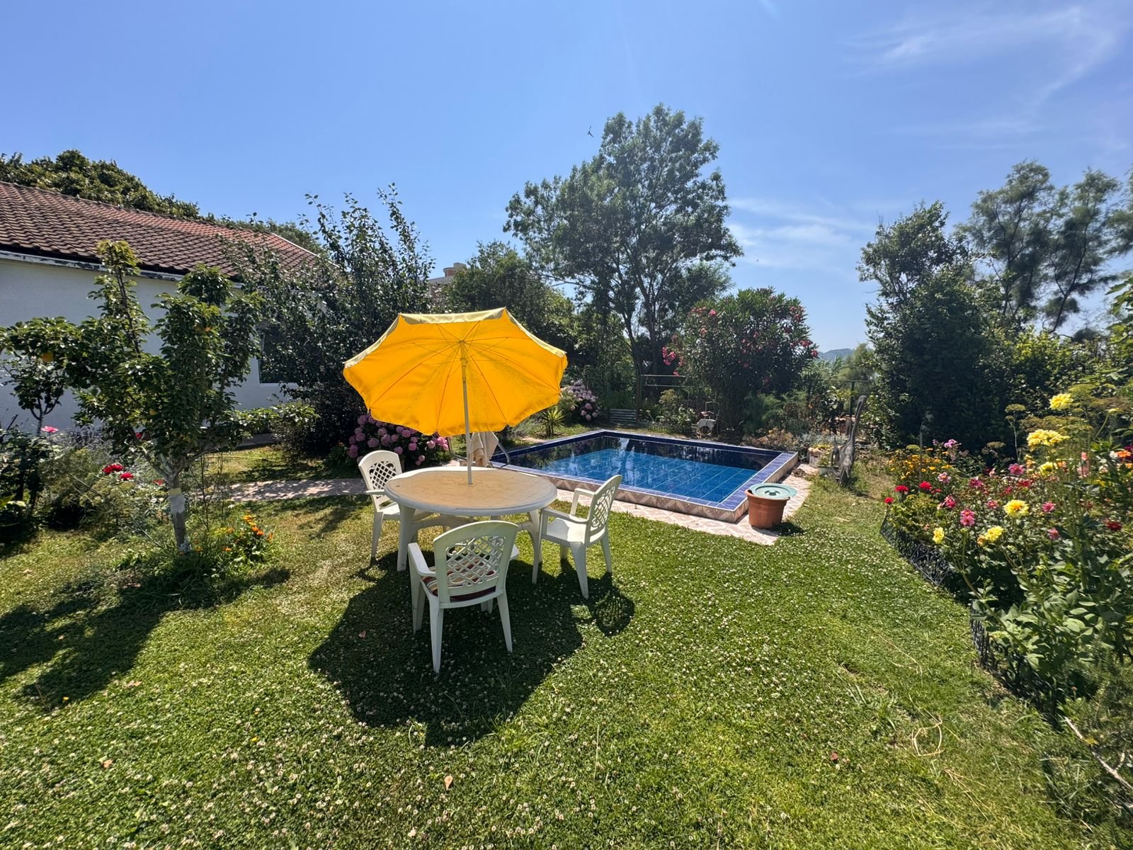 Chic outdoor oasis with pool, lush lawn, and stylish seating&mdash;ideal Ulcinj investment. Explore at immorenta.me by ekosphere doo.