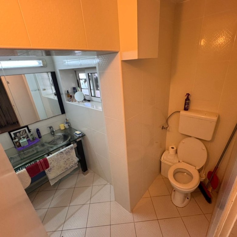 Modern Ulcinj bathroom with beige tiles, glass sink, and large mirror&mdash;prime real estate at immorenta.me by Ekosphere doo.