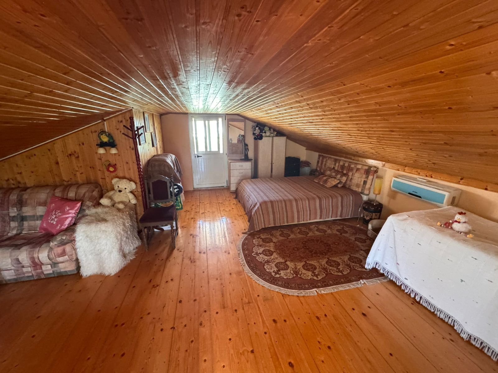 Charming attic room in Ulcinj, Montenegro with sloped wood ceiling, AC, and cozy decor&mdash;listed on immorenta.me by Ekosphere DOO.