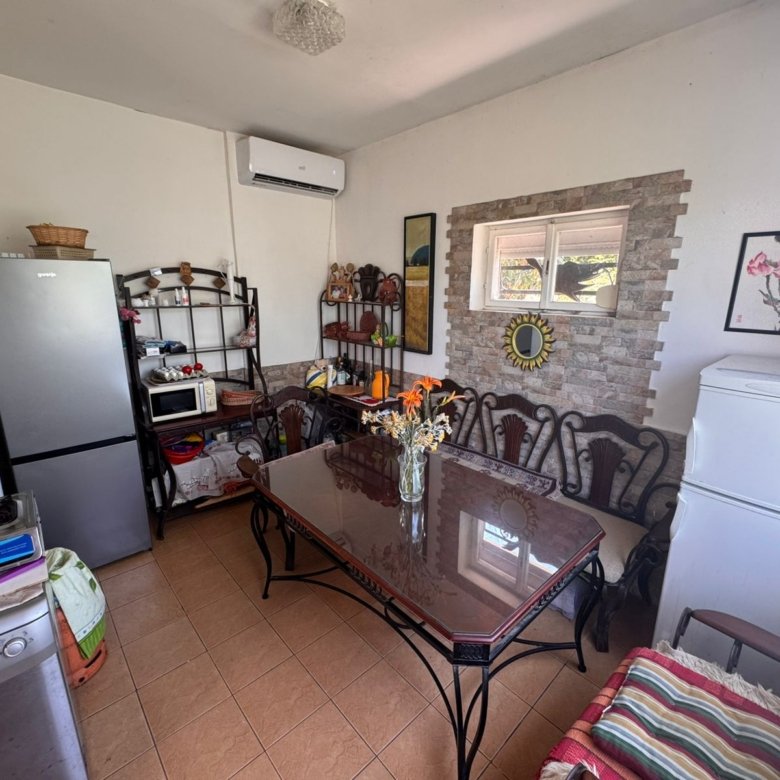 Modern kitchen-dining in Ulcinj: glass-top table, 6 chairs, appliances. Ideal Montenegro investment by Ekosphere&rsquo;s listings.me.