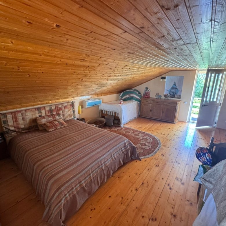 Charming Ulcinj attic bedroom with wood floors, sunlit double bed, and quality finishes&mdash;exclusive property via immorenta.me by ekosphere doo.