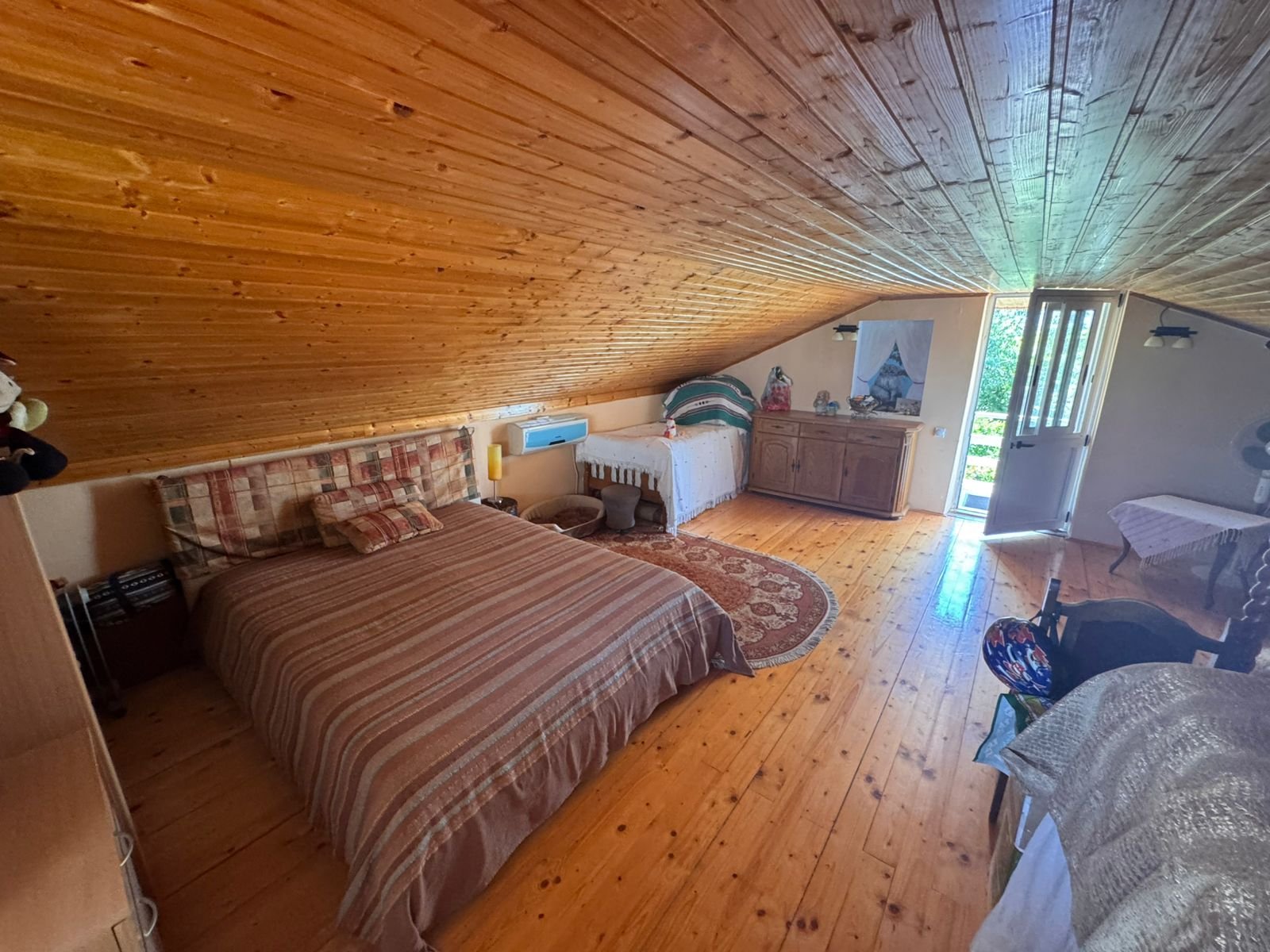 Charming Ulcinj attic bedroom with wood floors, sunlit double bed, and quality finishes&mdash;exclusive property via immorenta.me by ekosphere doo.