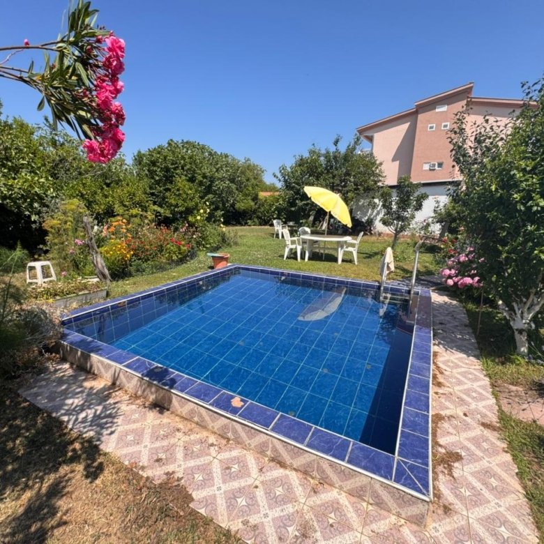 Charming blue-tiled pool in lush Ulcinj garden, perfect for relaxation. Prime Montenegro real estate by ekosphere doo&mdash;ideal investment.