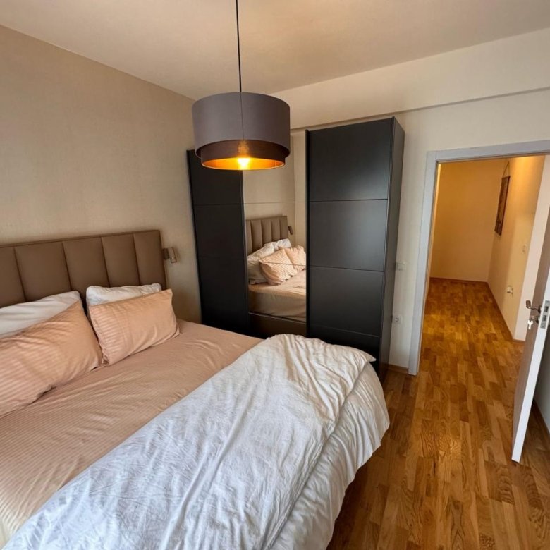 Bright Ulcinj bedroom with double bed, mirrored wardrobe; ideal real estate investment via immorenta.me by Ekosphere doo.