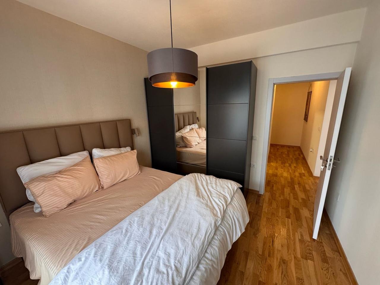 Bright Ulcinj bedroom with double bed, mirrored wardrobe; ideal real estate investment via immorenta.me by Ekosphere doo.