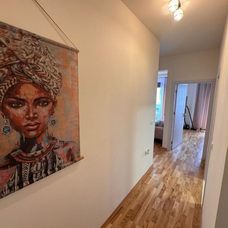 Elegant hallway with wood floors, art, and modern rooms&mdash;prime Ulcinj real estate by ekosphere doo on immorenta.me.