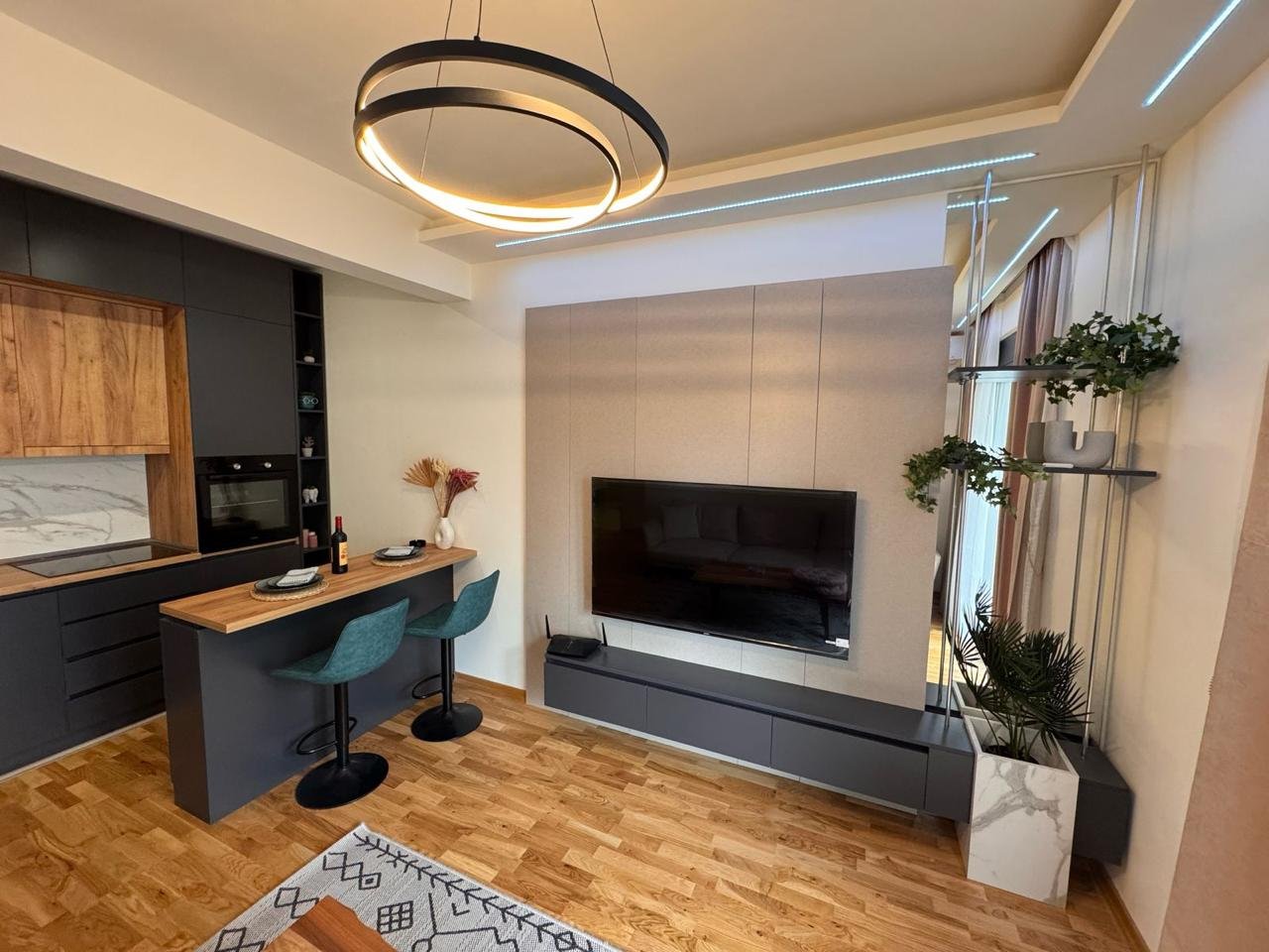 Stylish Ulcinj apartment with wood floors, island, teal barstools & sleek kitchen&mdash;investment on immorenta.me by ekosphere doo.