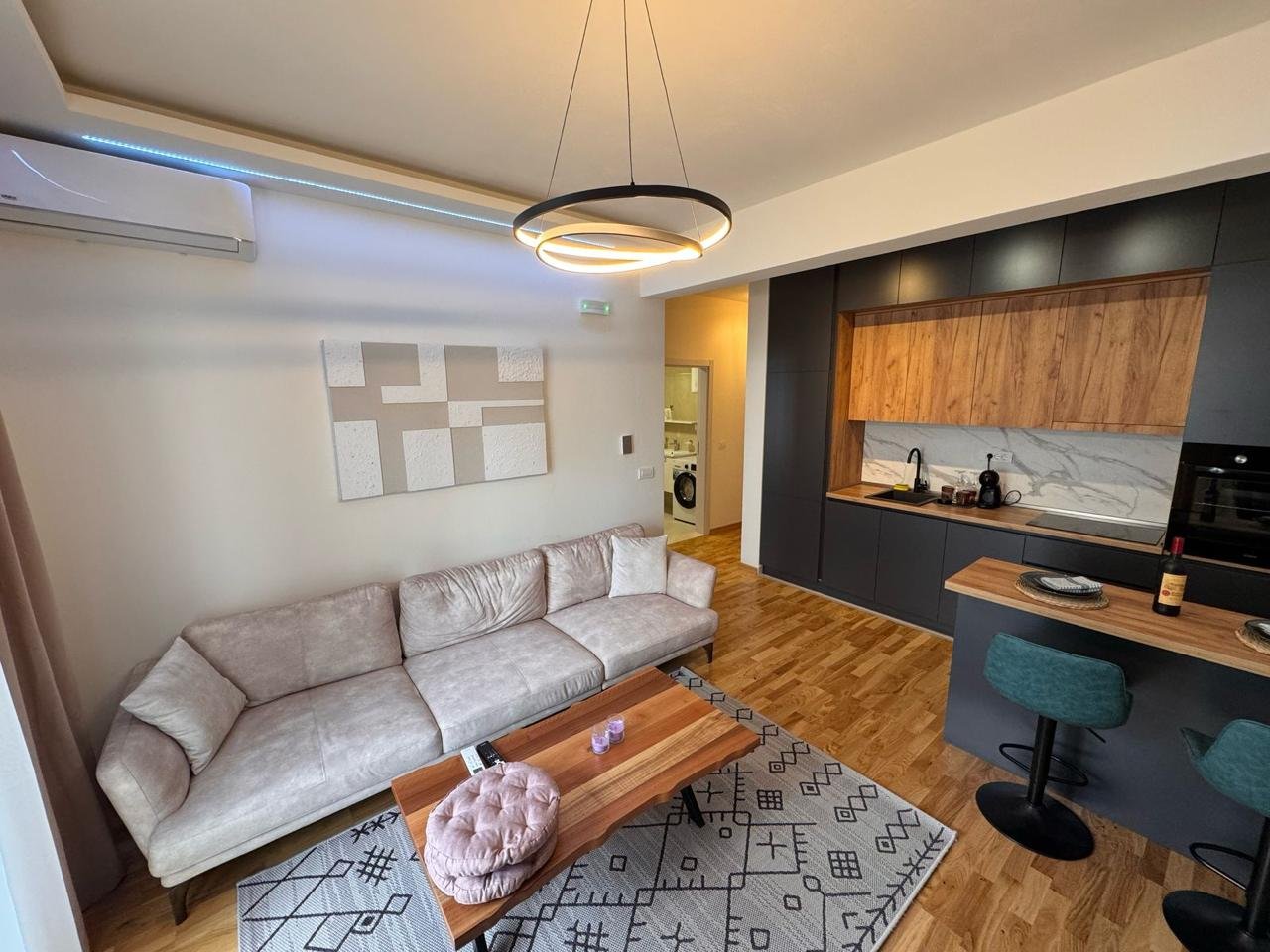 Stylish Ulcinj Montenegro apartment for sale: modern living/kitchen, beige sofa, ekosphere kitchen&mdash;exclusive at immorenta.me.