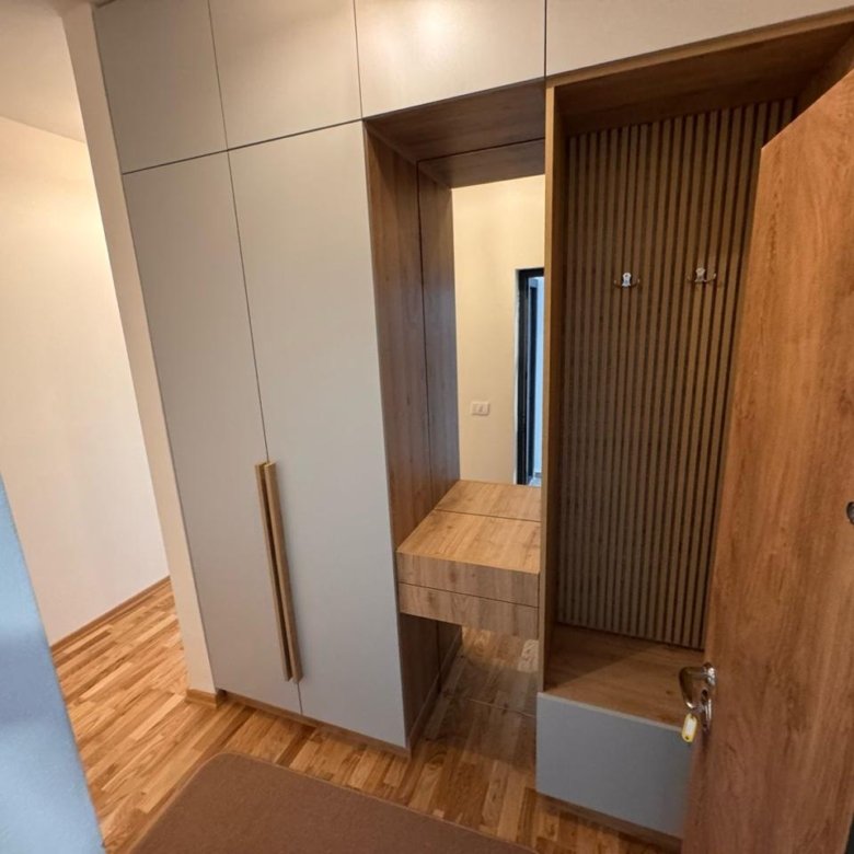 Bright hallway with elegant wood floors, modern cabinetry, and stylish entryway&mdash;prime Ulcinj real estate from immorenta.me.