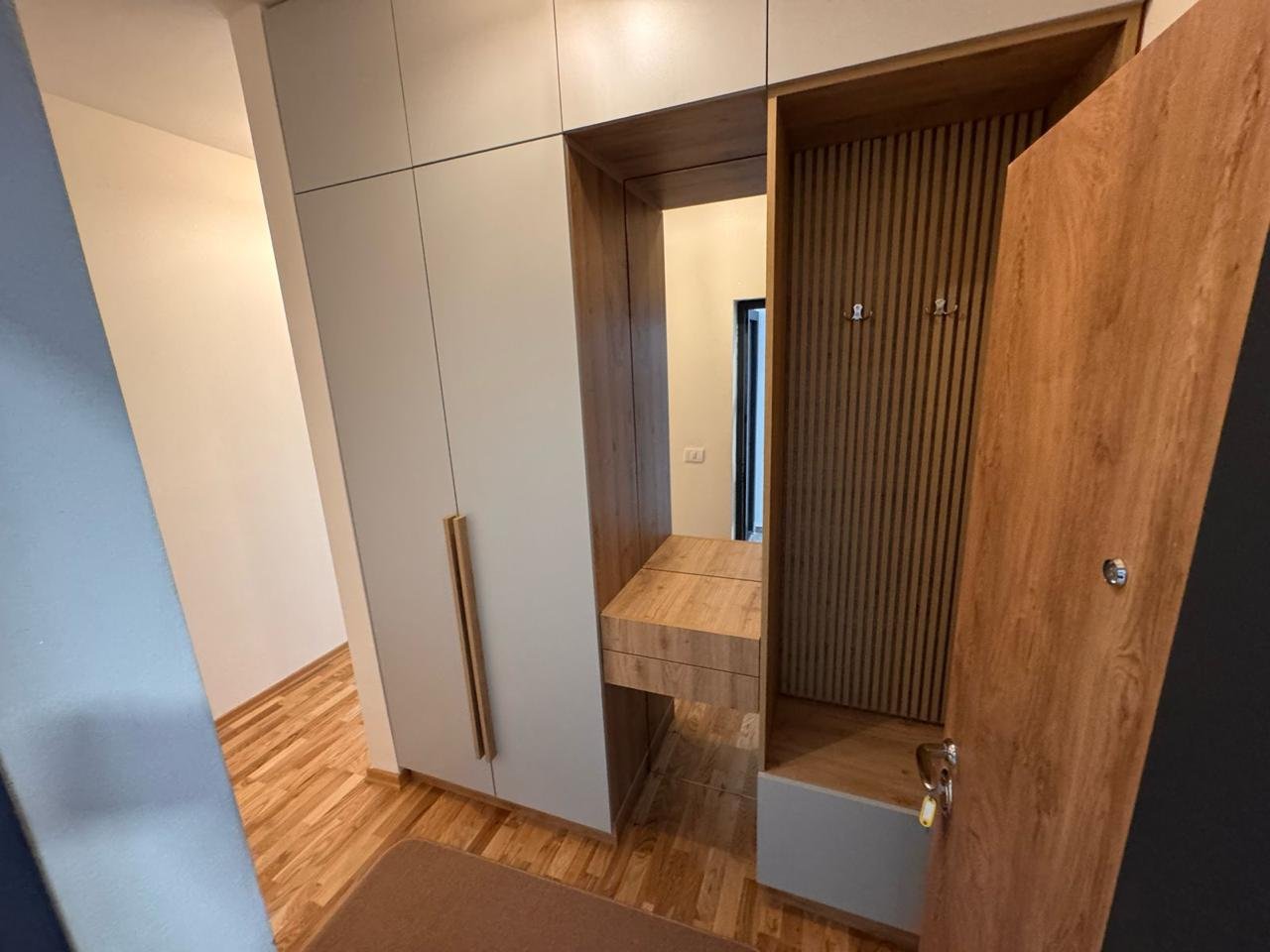 Bright hallway with elegant wood floors, modern cabinetry, and stylish entryway&mdash;prime Ulcinj real estate from immorenta.me.