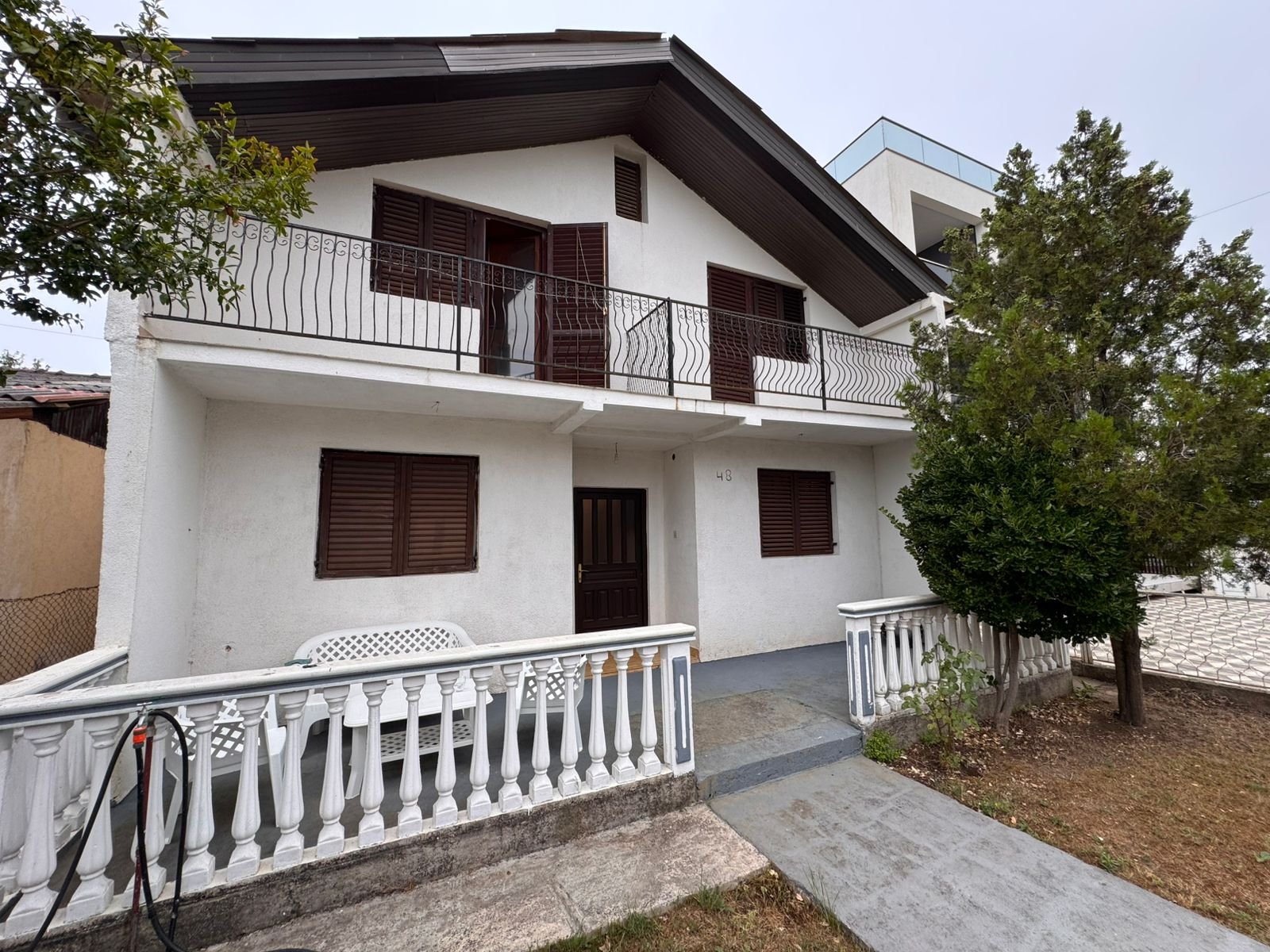 Elegant two-story Ulcinj home with balcony, porch, lush yard&mdash;prime Montenegro real estate at immorenta.me, by ekosphere doo.