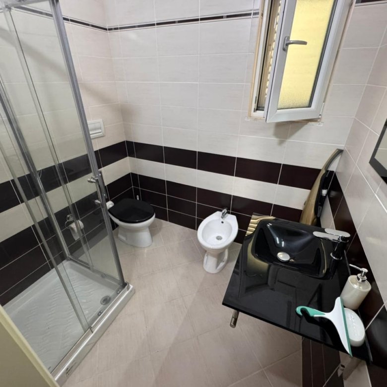 Contemporary Ulcinj bathroom: glass shower, bidet, luxe sink, modern tiles. Exclusive on immorenta.me by ekosphere doo.