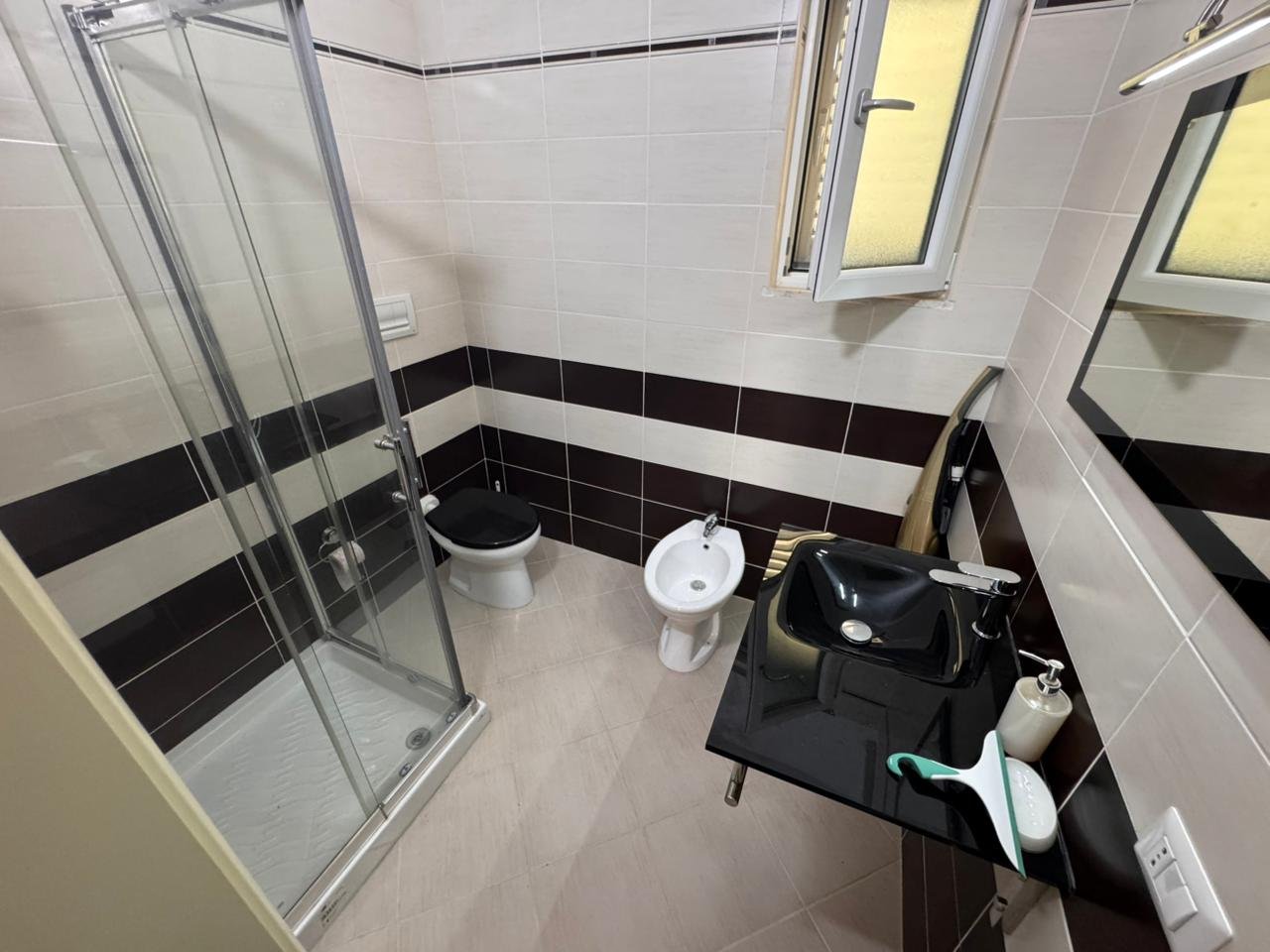 Contemporary Ulcinj bathroom: glass shower, bidet, luxe sink, modern tiles. Exclusive on immorenta.me by ekosphere doo.