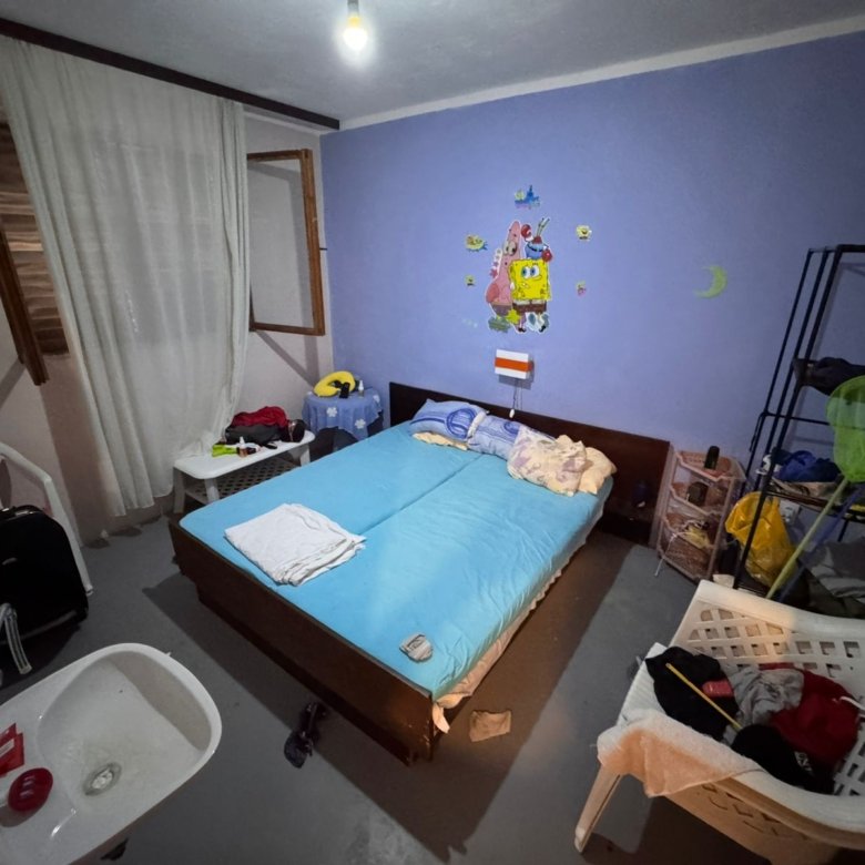 Contemporary Ulcinj bedroom with blue accents, double bed, open window. Invest in Montenegro real estate at immorenta.me.