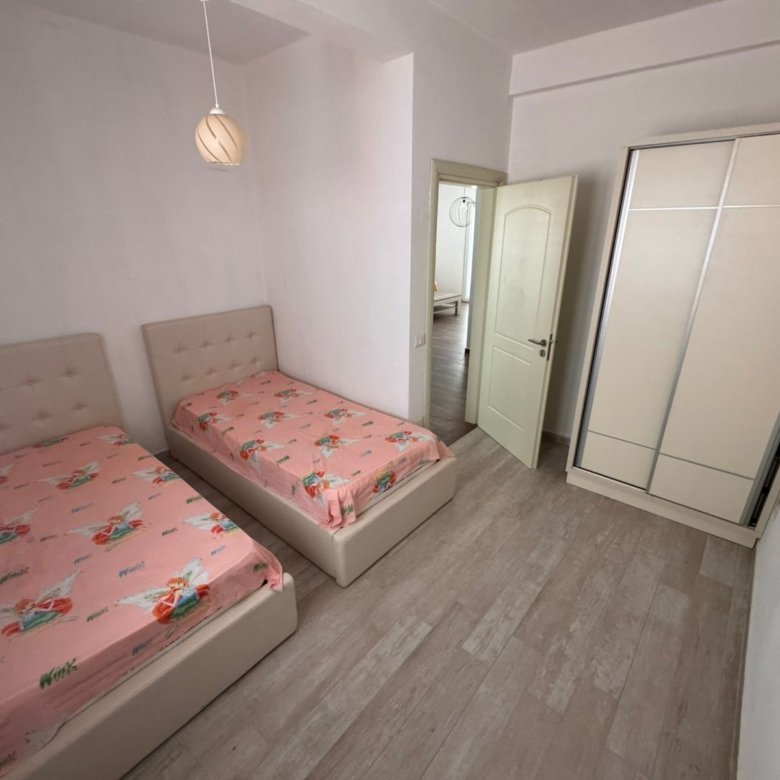 Ulcinj real estate gem: bright bedroom with twin beds, stylish wardrobe, and wood floors. Ekosphere quality&mdash;immorenta.me project.