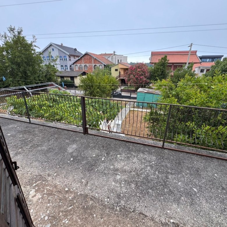 Stunning balcony view over lush fenced garden, sheds & prime Ulcinj properties&mdash;exclusive at immorenta.me by Ekosphere doo.