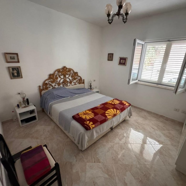 Charming Ulcinj bedroom for sale: elegant double bed, ornate headboard, sunlit space&mdash;ideal Montenegro investment by ekosphere doo.