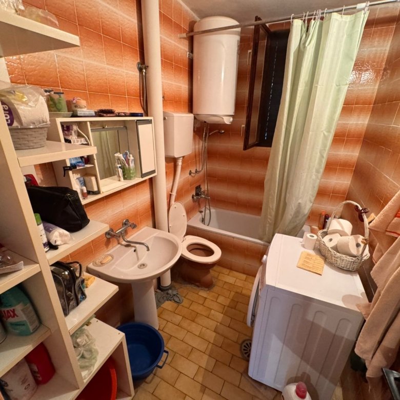 Modern Ulcinj bathroom with patterned tiles, tub, washing machine&mdash;ideal investment. Exclusive to immorenta.me by ekosphere doo.