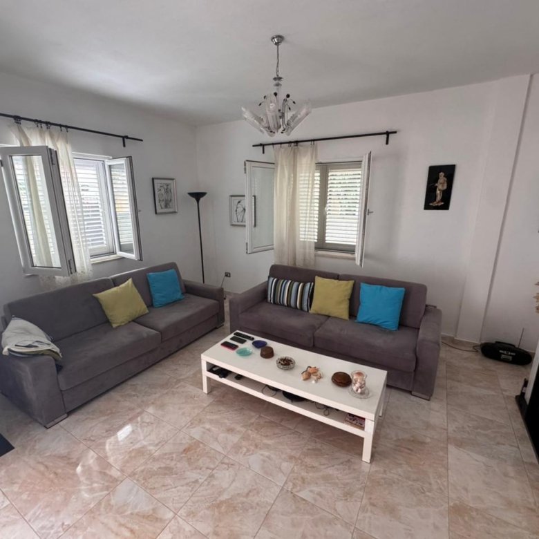 Contemporary Ulcinj living room: 2 gray sofas, chic fireplace, bright windows&mdash;prime real estate by Ekosphere & immorenta.me.