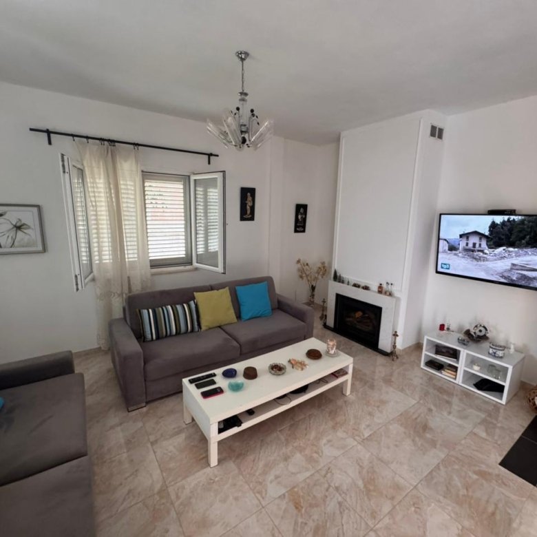 Stylish Ulcinj living room with gray sofas, fireplace, natural light&mdash;prime Montenegro investment via immorenta.me by Ekosphere.