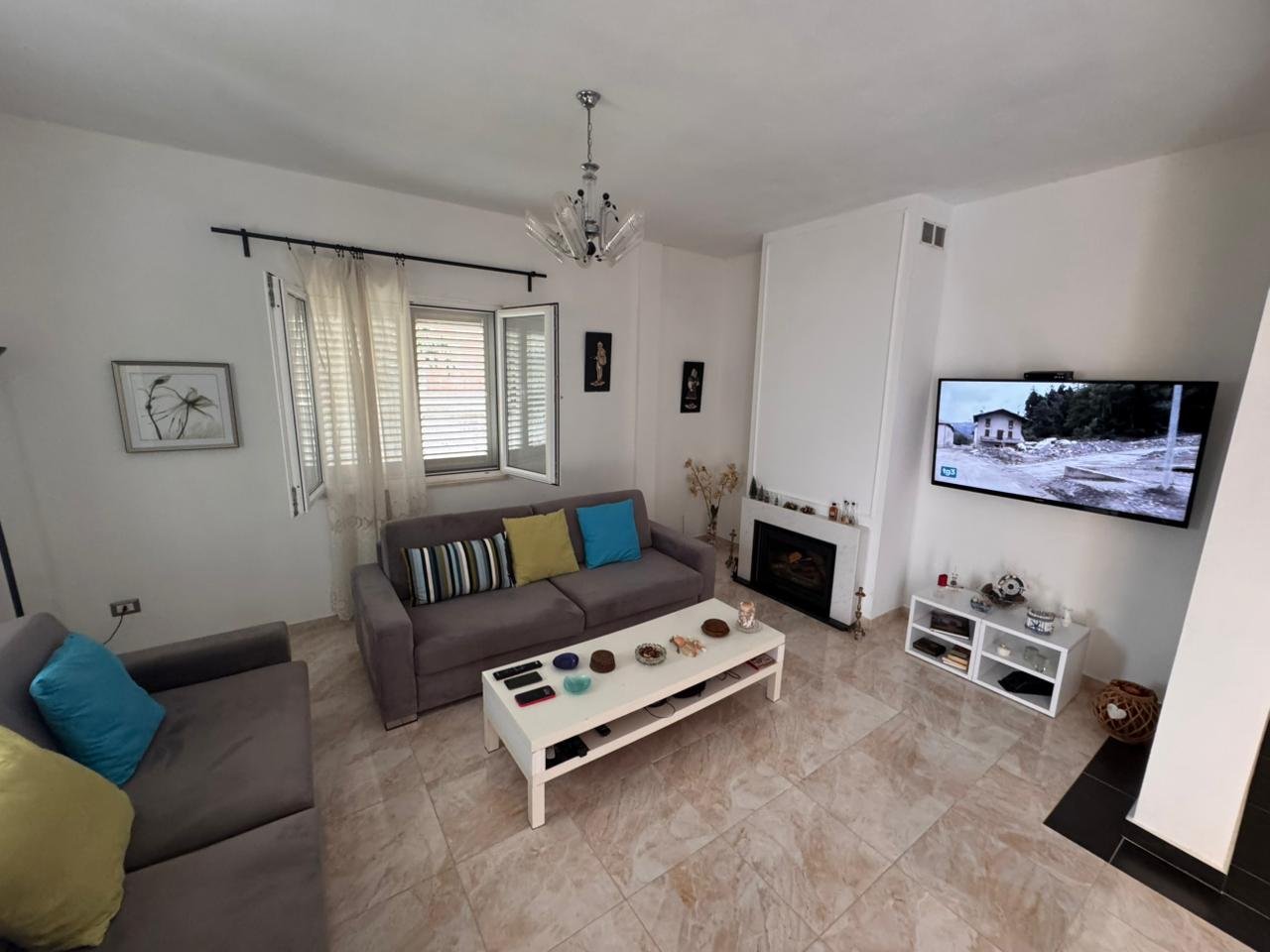 Stylish Ulcinj living room with gray sofas, fireplace, natural light&mdash;prime Montenegro investment via immorenta.me by Ekosphere.