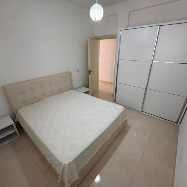 Modern bedroom in Ulcinj: double bed, sleek wardrobe, tiled floors&mdash;ideal Montenegro investment. Exclusive on immorenta.me by Ekosphere doo.